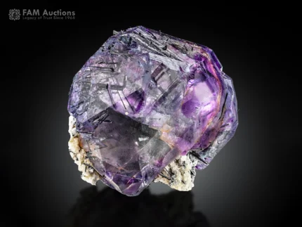 Purple fluorite crystals with dark riebeckite inclusions and contrasting albite.