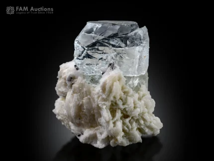 Clear naturally etched goshenite crystal on white albite matrix.