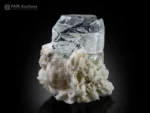 Clear naturally etched goshenite crystal on white albite matrix.