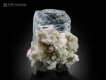 Clear naturally etched goshenite crystal on white albite matrix.