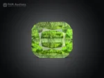 14.35 carat cushion cut green Peridot with dark Ludwigite inclusions from Pakistan.