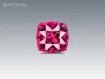 0.95 carat cushion cut rhodolite garnet with intense raspberry pink color, eye-clean clarity, and brilliant sparkle.