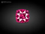 0.95 carat cushion cut rhodolite garnet with intense raspberry pink color, eye-clean clarity, and brilliant sparkle.