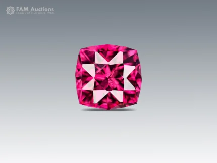 0.95 carat cushion cut rhodolite garnet with intense raspberry pink color, eye-clean clarity, and brilliant sparkle.