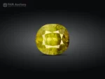 2.35 carat cushion cut tourmaline from Pakistan with green and honey tones, broad facets, and natural inclusions