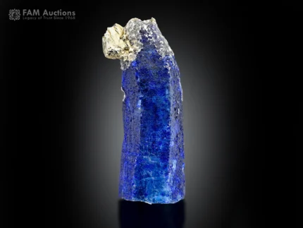 Blue afghanite crystal coated with lazurite and accented by pyrite, showing intense orange fluorescence under UV light.