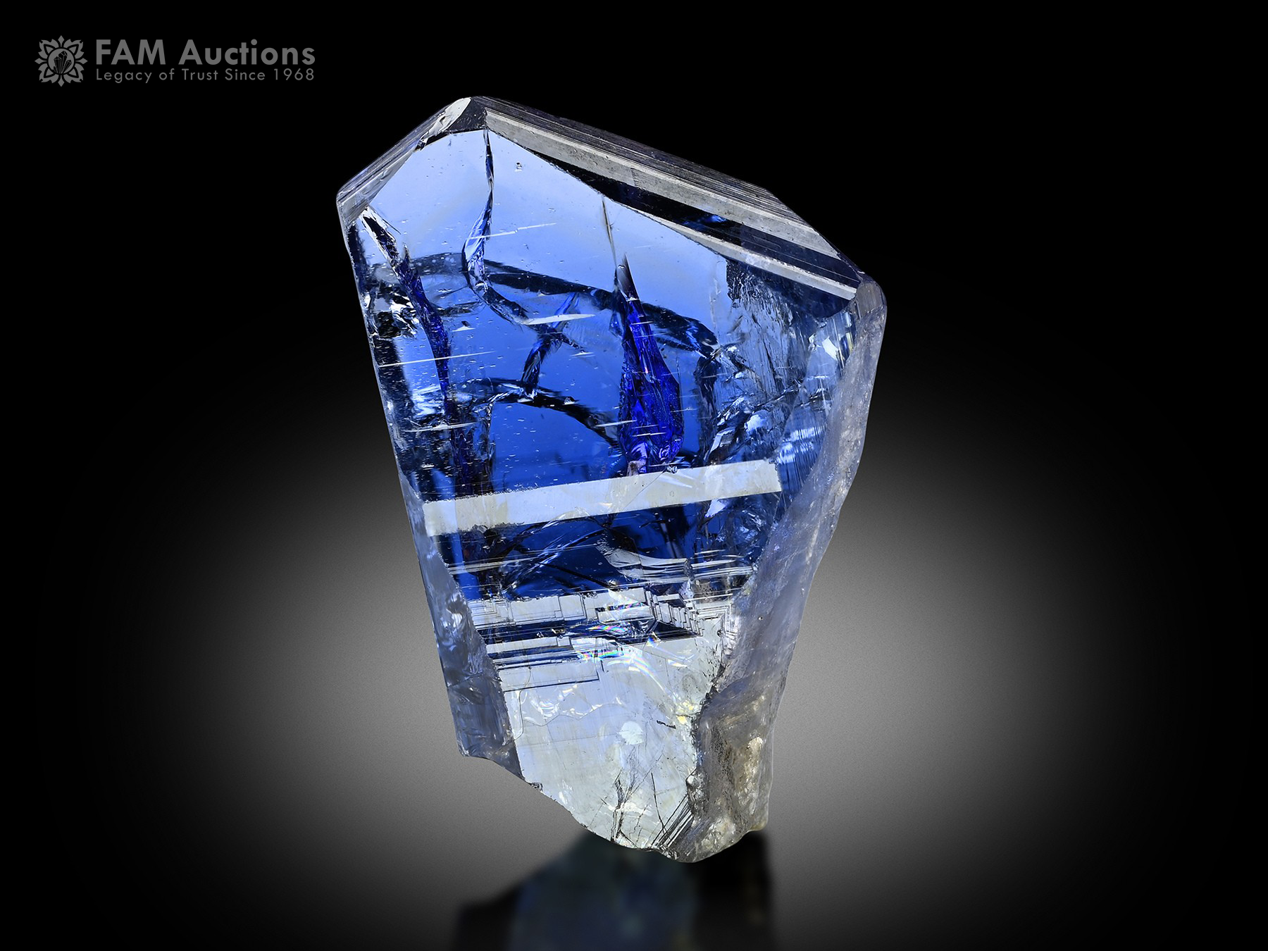 Blue Violet Tanzanite Crystal TNZ-23 Gemmy blue-violet tanzanite crystal displaying a sharp termination, brilliant luster, excellent transparency, and fascinating internal formations.