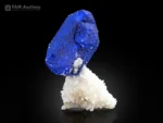 Rich deep blue lazurite crystal perched on bright white matrix with strong contrast and attractive natural form.