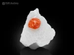 Vivid mandarin-orange spessartine garnet crystal with sharp, lustrous faces beautifully positioned on a contrasting white matrix from Pakistan.
