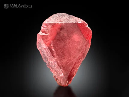 Vivid hot-red rhodochrosite crystal with an elegant shape, sharp edges, a well-defined termination, a gemmy appearance, and brilliant natural luster.