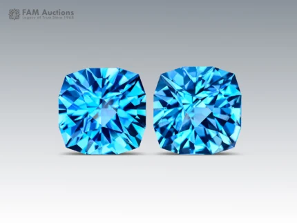 Matched pair of vibrant Swiss Blue Topaz gemstones featuring elegant fancy cushion cuts, brilliant faceting, vivid blue color, and excellent sparkle.